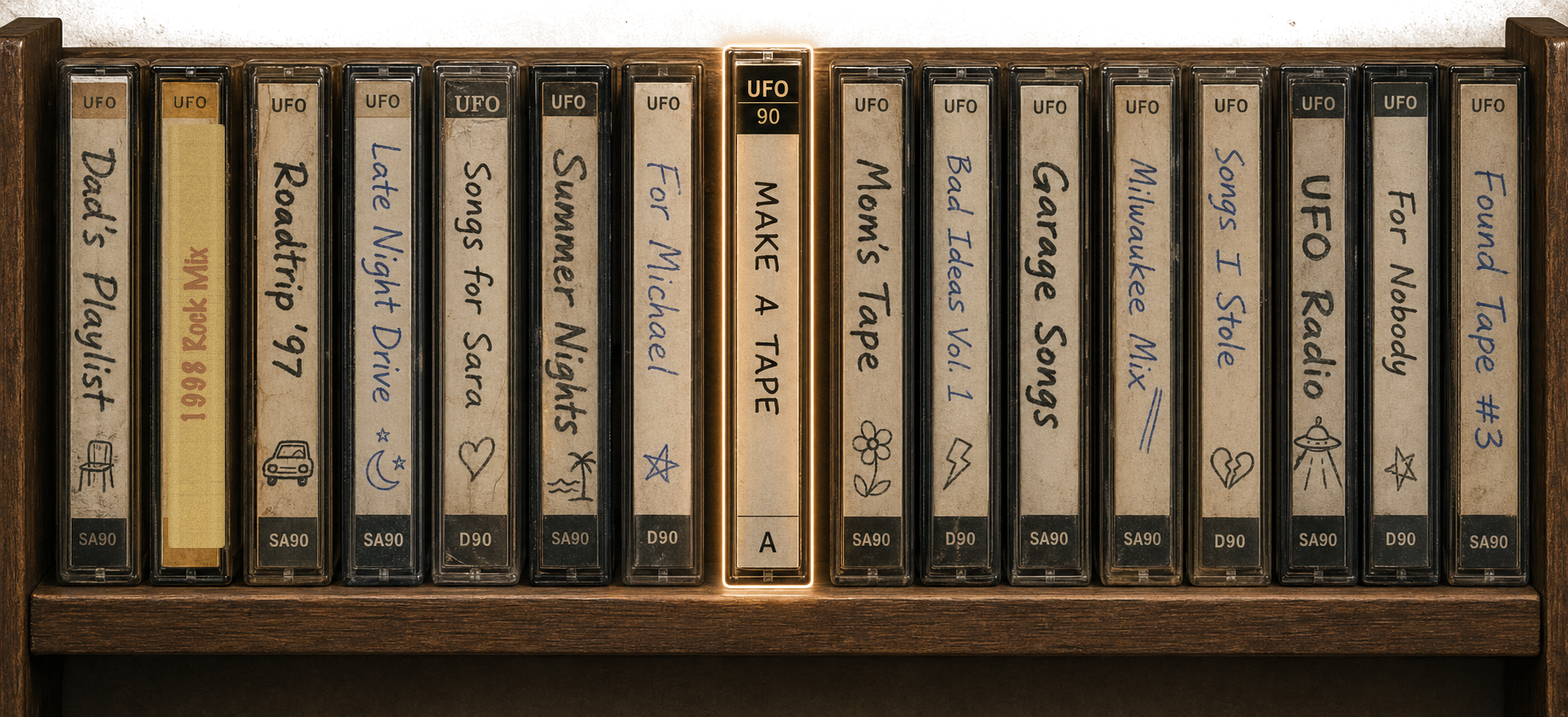 UFO cassette shelf with handwritten labels including Roadtrip ’97, Late Night Drive, and Make a Tape